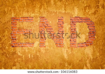 old plastered wall with crumbling plaster in the form of the word end