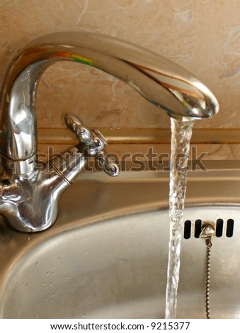 Tap with run water in the kitchen