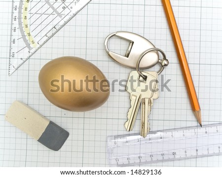 plotting paper with working tools eraser, ruler, pencil, key and golden egg