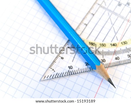 triangle and pencil at the exercise 	checked book