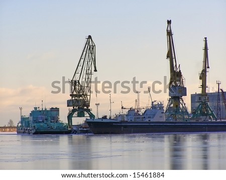 winter cargo side port with big ships and cranes