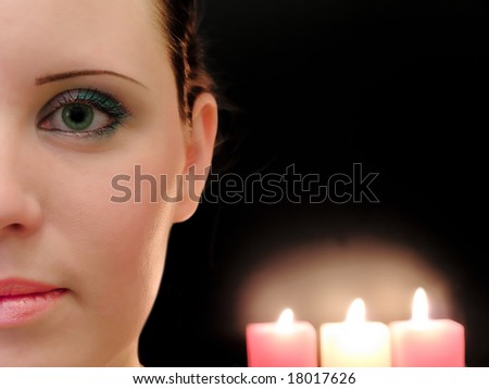half woman face with the three candles