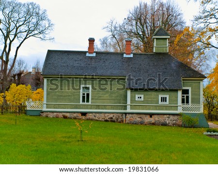 rural green painted house in the autumn village