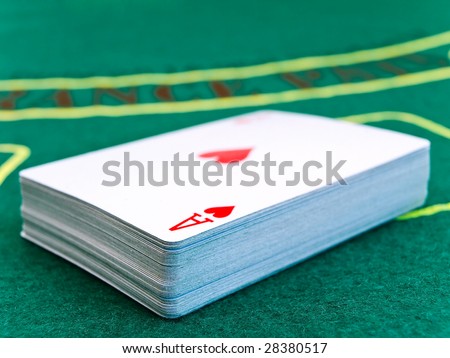 deck of playing cards in a casino on the green table