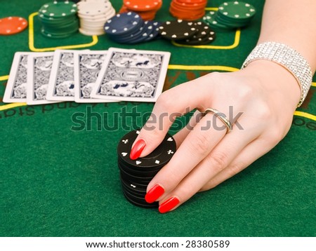 hand of women who makes a bet at the casino