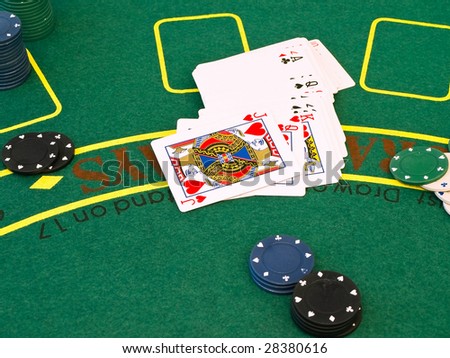 cards and chips at the green table in the casino