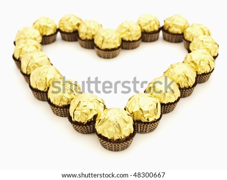 heart shape from sweets in golden candy wrapper