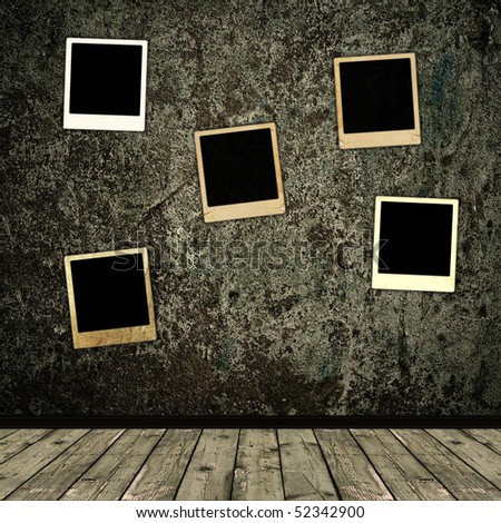 old photo frames over the grunge wall background