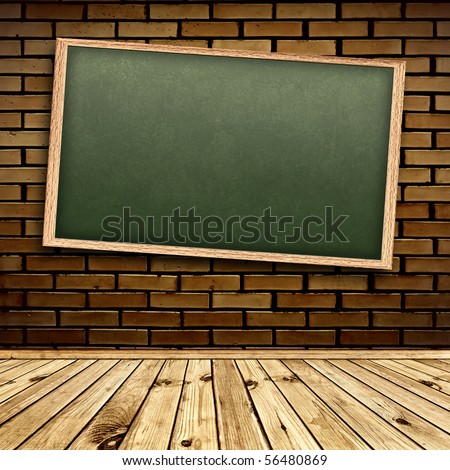 Empty school blackboard at brick wall in interior with wooden floor