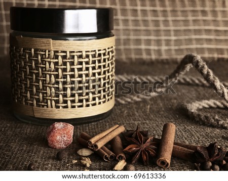 spice mix for hot wine over the burlap background with glass jar (shallow DOFF)