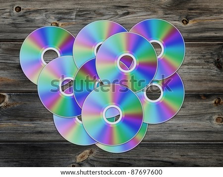 cd disks over the wooden background