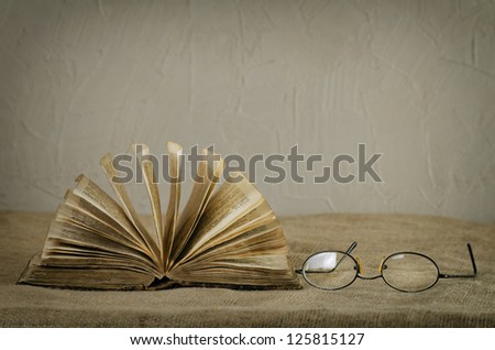 Old Bible (19th century) and glasses on canvas