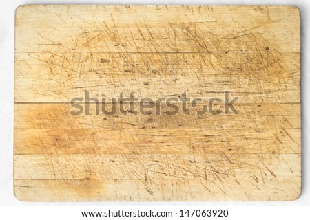Old and used natural wooden cooking board with cuts
