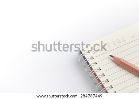 pencil on a notebook on white background