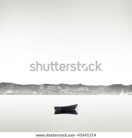 lonely boat on the flat surface of water in black and white style