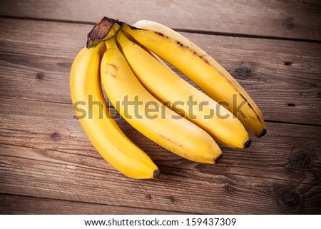 Fresh bananas on wooden background