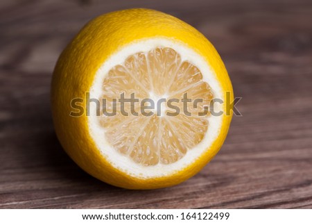single lemon on wooden background
