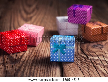 small colorful gift boxes on wooden background