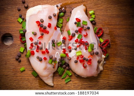 Fresh chicken meat on wooden board