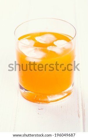 Orange drink on wooden background