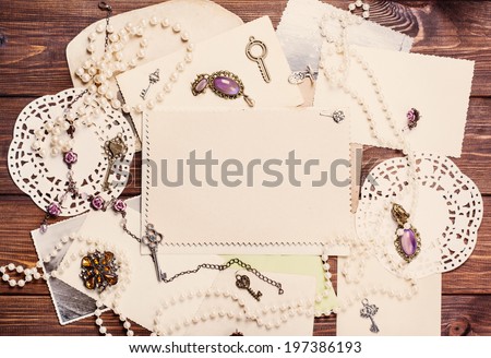 old paper sheets surrounded by retro women\'s accessories