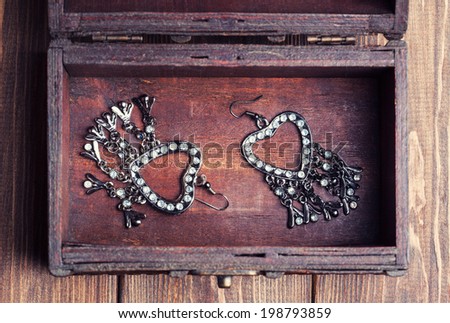 vintage earrings in a form of hearts inside old treasure chest