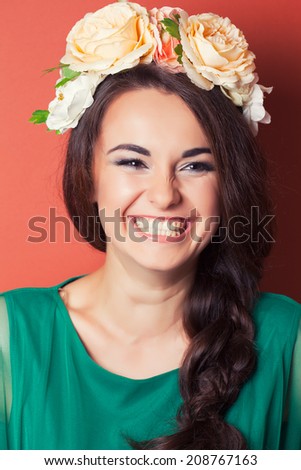 beautiful young woman wearing wreath against red background