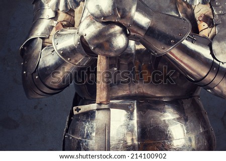 knight wearing armor and standing with two-handed sword