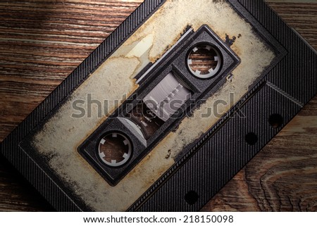 audio cassette with magnetic tape on wooden background