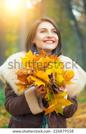 Young woman posing in autumn park
