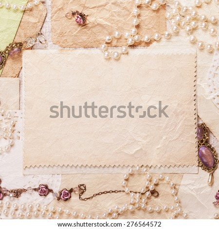 old paper sheets surrounded by retro women\'s accessories