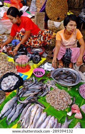YANGON, MYANMAR - March 24, 2013 : Unidentified women selling fresh seafood at morning market in Yangon. Yangon is the capital of Myanmar