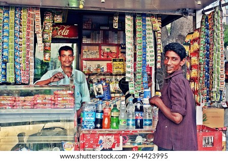 SRINAGAR, INDIA - JUNE 11, 2012 : Grocery owner selling drinking water and snacks in SRINAGAR, India.
