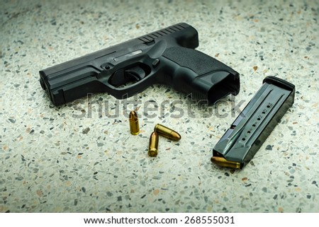 Gun with magazine and ammo on floor