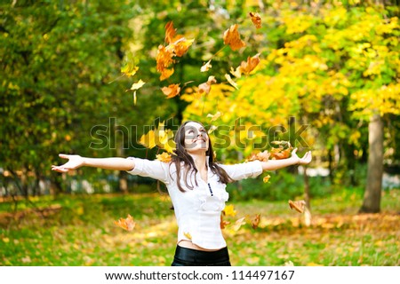 woman threw up autumn leaves