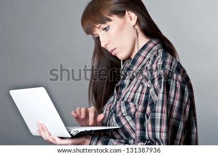 beautiful woman with a laptop isolated on a gray background