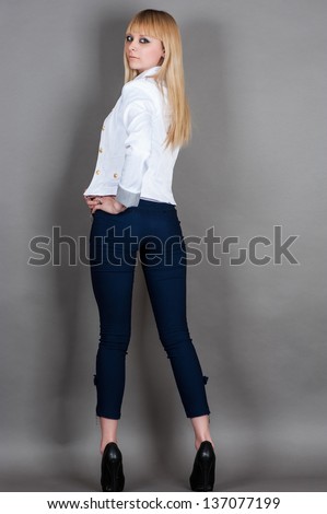 fashionable young woman stands full length half turn