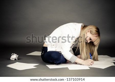 beautiful female student writing on paper