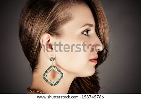 profile of beautiful woman with pierced ears