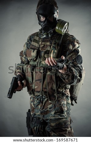 man in uniform with a gun in hands