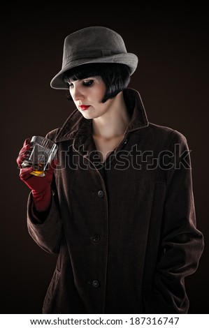 beautiful fashionable woman in the image of the detective