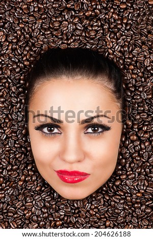 beautiful woman face in the coffee beans