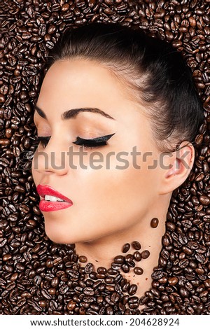 woman face with closed eyes in the coffee beans