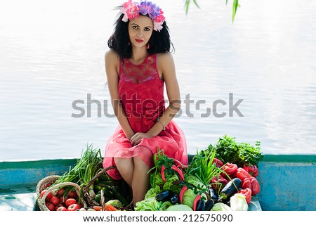 elegant woman sitting on a boat with vegetables