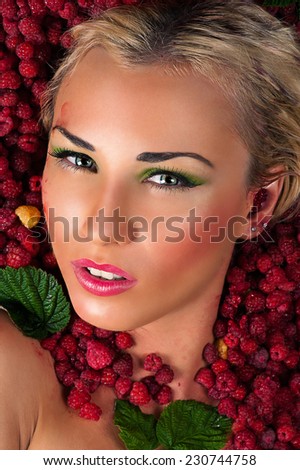 sensual female face in raspberries