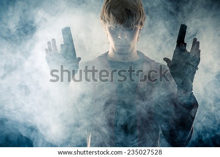 manly hero with pistols in hands in the smoke