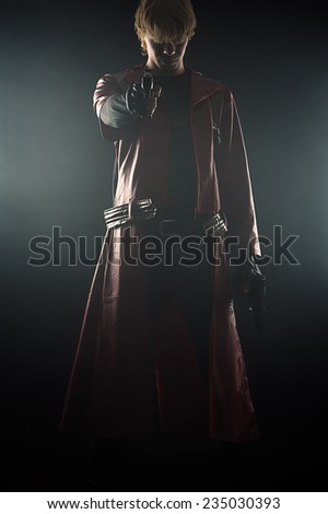 hero with pistols in hands aiming smoke isolated on black background