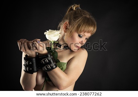 woman slave in handcuffs with flower in hand