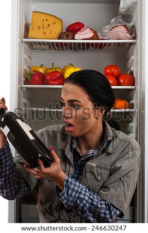 dirty beggar hungry stares at the bottle of wine