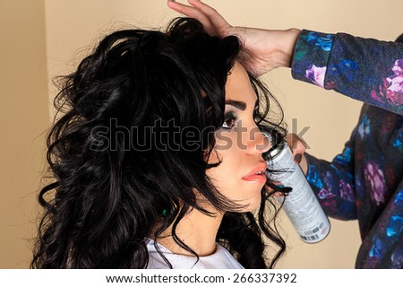 woman with magnificent curly hair in a hair salon
